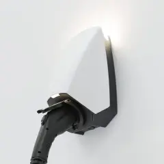 A sleek white and black electric vehicle charger, branded "SEREN," is mounted on a white wall, ready to power up.