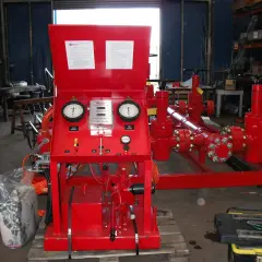 Red industrial equipment with gauges displaying pressure and flow velocity units.
