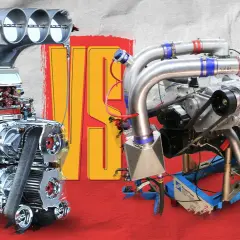 Two powerful, heavy duty motor engines, one supercharged and gleaming, the other turbocharged and complex, stand ready for action.