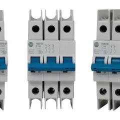 Three white circuit breakers with blue toggles. The middle one is a triple-pole slow blow circuit breaker, while the outer two are single-pole.