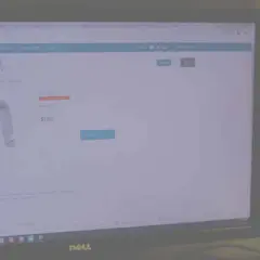A person views a Heitek Automation website displaying a metal bracket for $1.70.