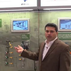 Man explains IO-Link Master with Ethernet/IP, showcasing sensor data and automatic configuration for industrial automation.