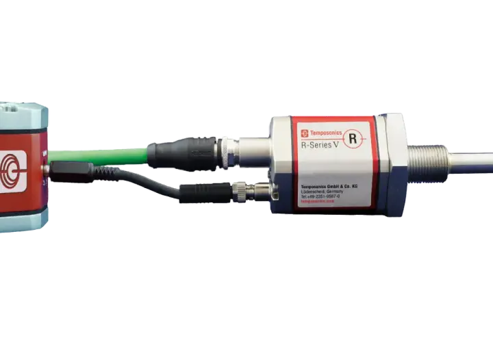 Temposonics R-Series V sensors, with a red and silver housing, connected via USB and other cables.
