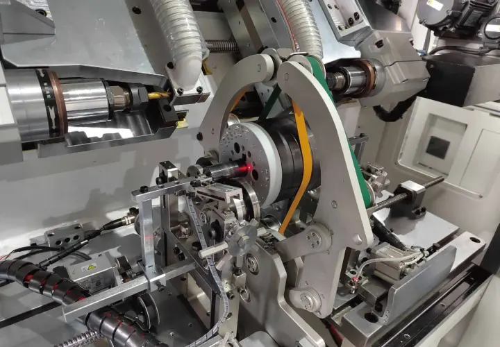 Precision machinery for electric motor balancing, featuring a spinning rotor with a red laser guide and automated arms.