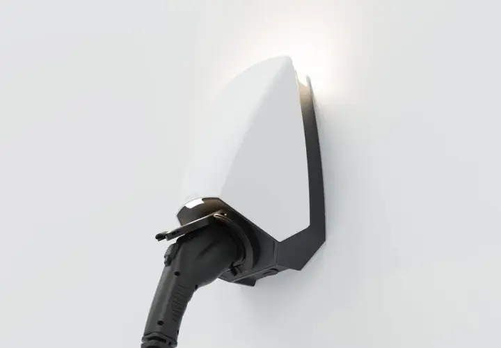 A sleek white and black electric vehicle charger, branded "SEREN," is mounted on a white wall, ready to power up.