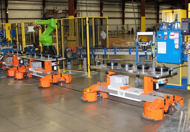 Automated guided vehicles and a robotic arm work together in a factory setting, showcasing advanced fori automation.