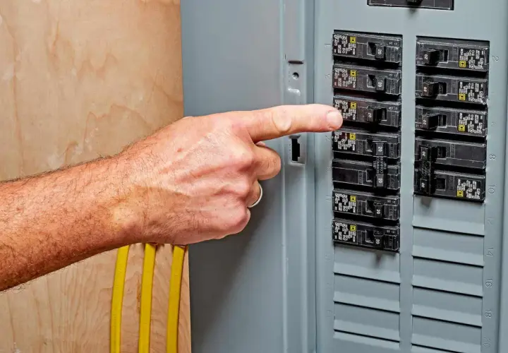 A finger points to a breaker switch, possibly indicating a breaker switch breakdown or a need for troubleshooting.