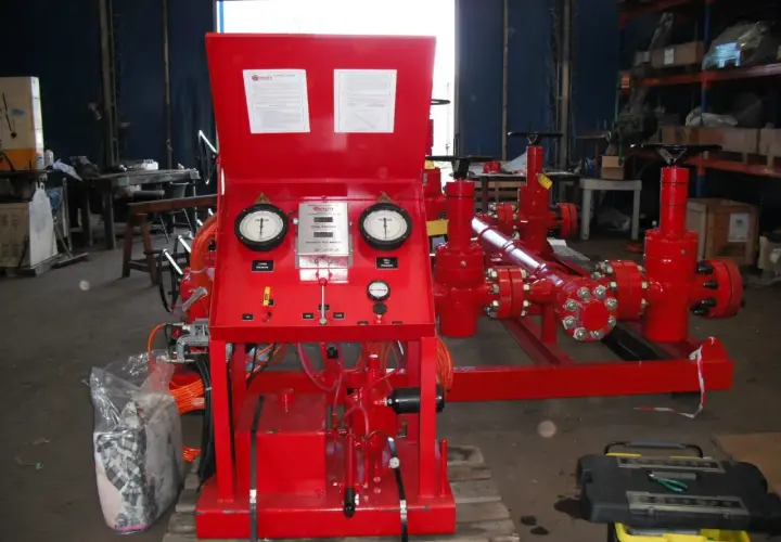 Red industrial equipment with gauges displaying pressure and flow velocity units.