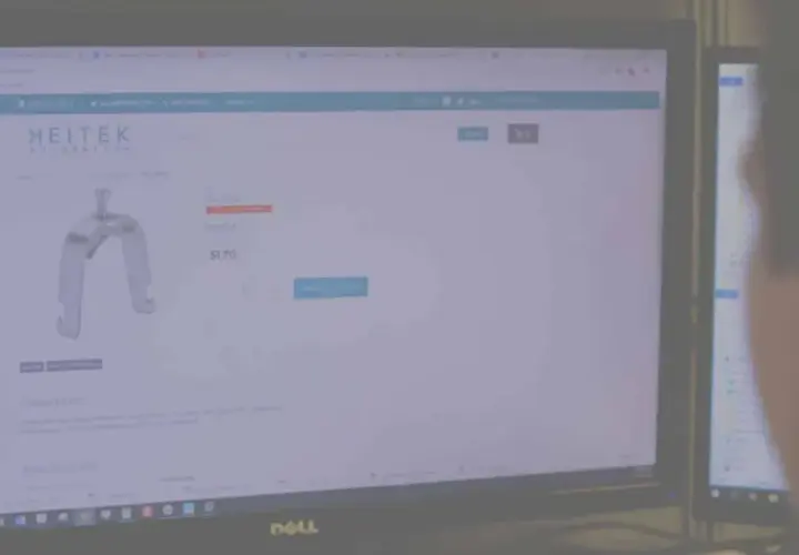 A person views a Heitek Automation website displaying a metal bracket for $1.70.