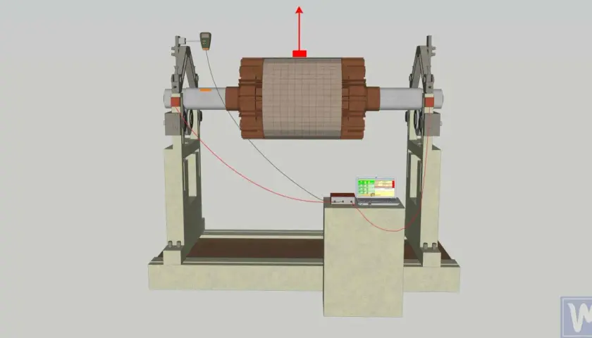 A rotor is mounted on a stand with sensors and a laptop for rotor balancing.