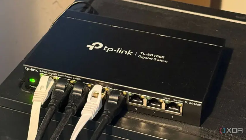 A TP-Link 8-port Gigabit Easy Smart Switch, a type of unmanaged ethernet switch, connects devices.