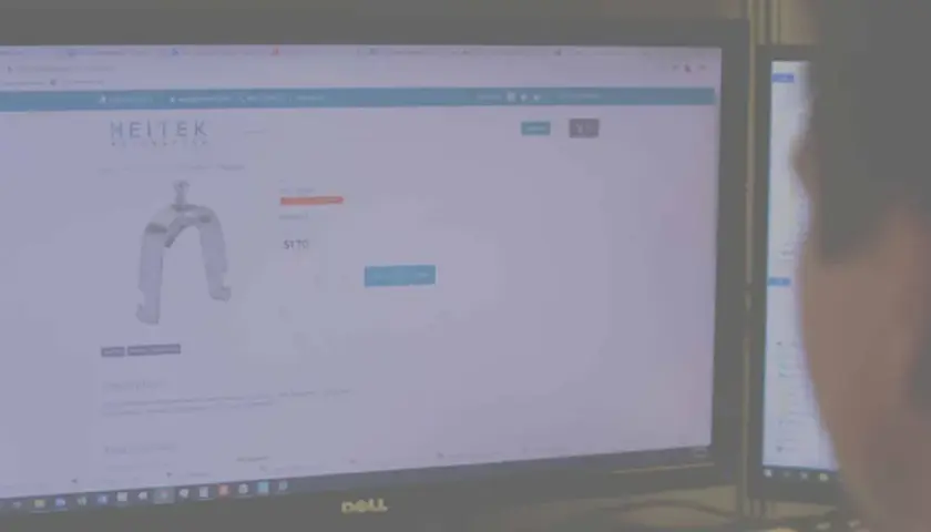A person views a Heitek Automation website displaying a metal bracket for $1.70.