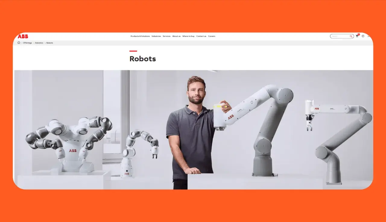 A man stands with several robotic arms, showcasing automation solutions of America.