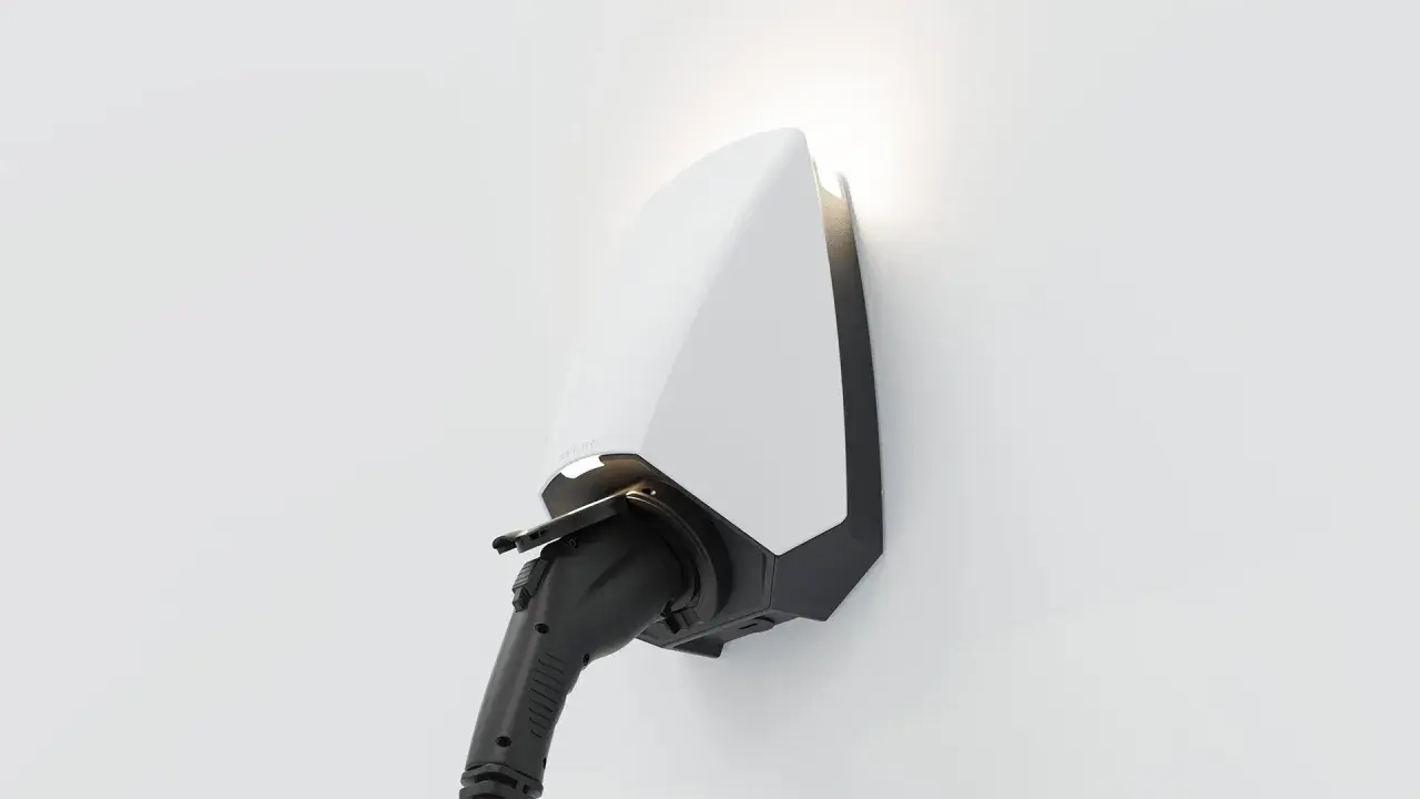 A sleek white and black electric vehicle charger, branded "SEREN," is mounted on a white wall, ready to power up.