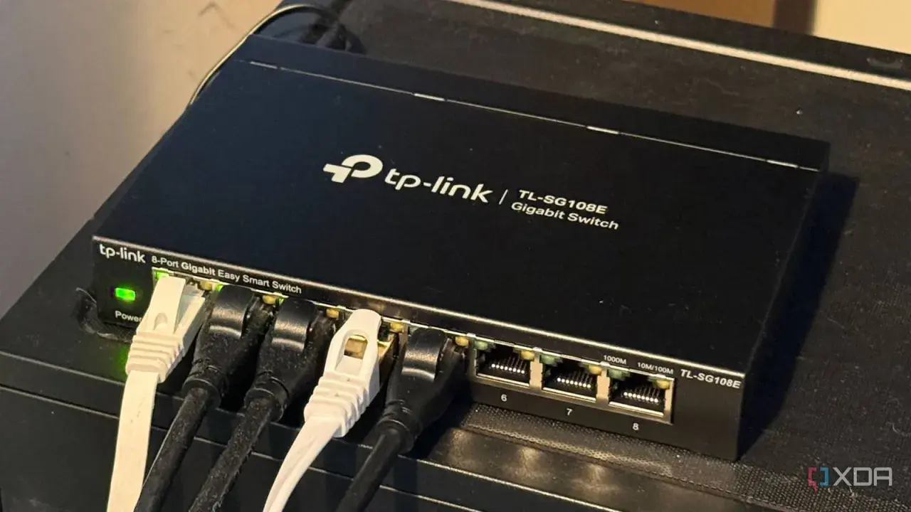 A TP-Link 8-port Gigabit Easy Smart Switch, a type of unmanaged ethernet switch, connects devices.