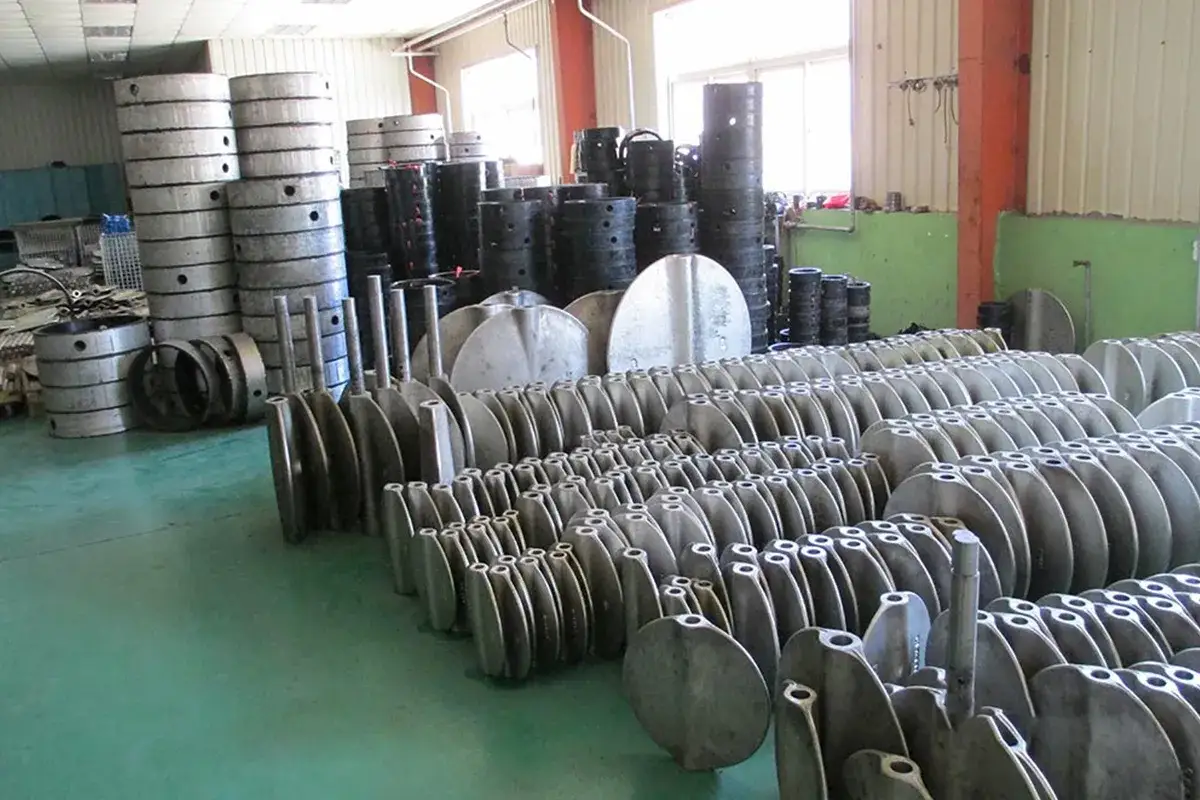 Rows of metal components, likely for zwick valves, are neatly arranged in a warehouse.
