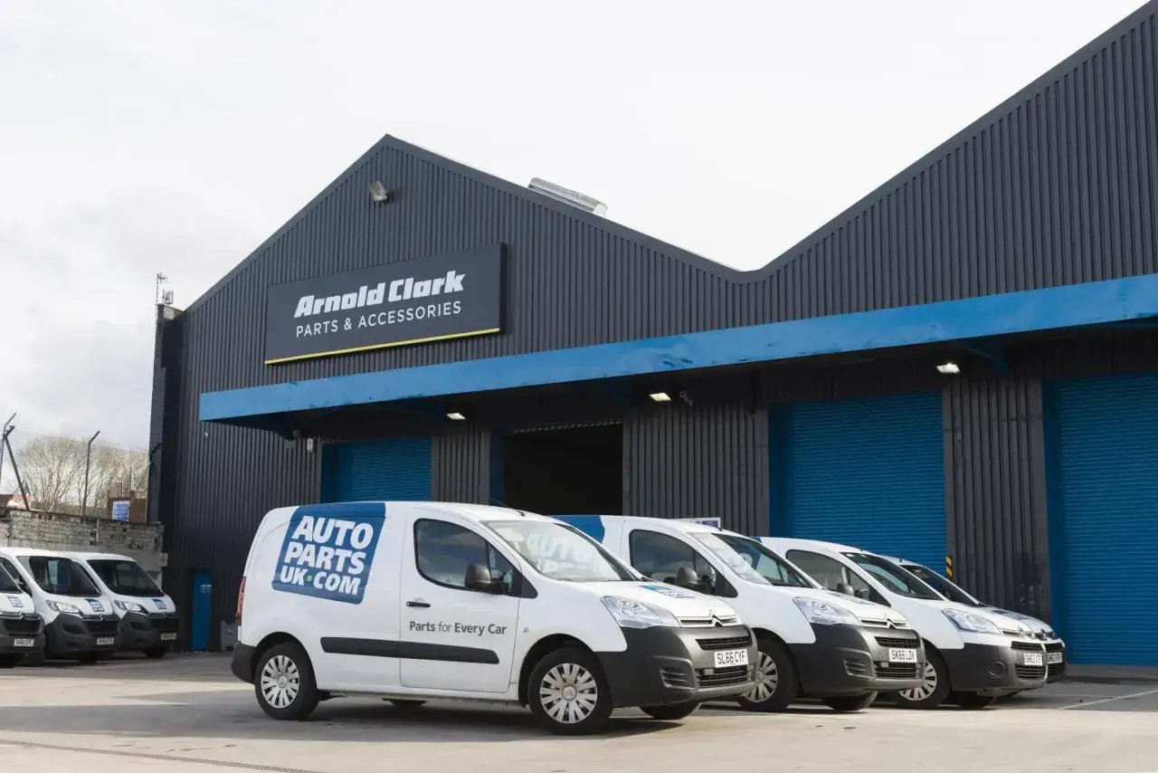 Arnold Clark Auto Parts UK.com vans lined up outside the warehouse.