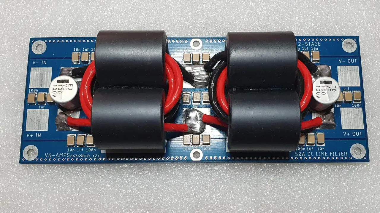 A 2-stage 50A DC line filter board with two large toroidal chokes, designed for RFI EMI filtering.
