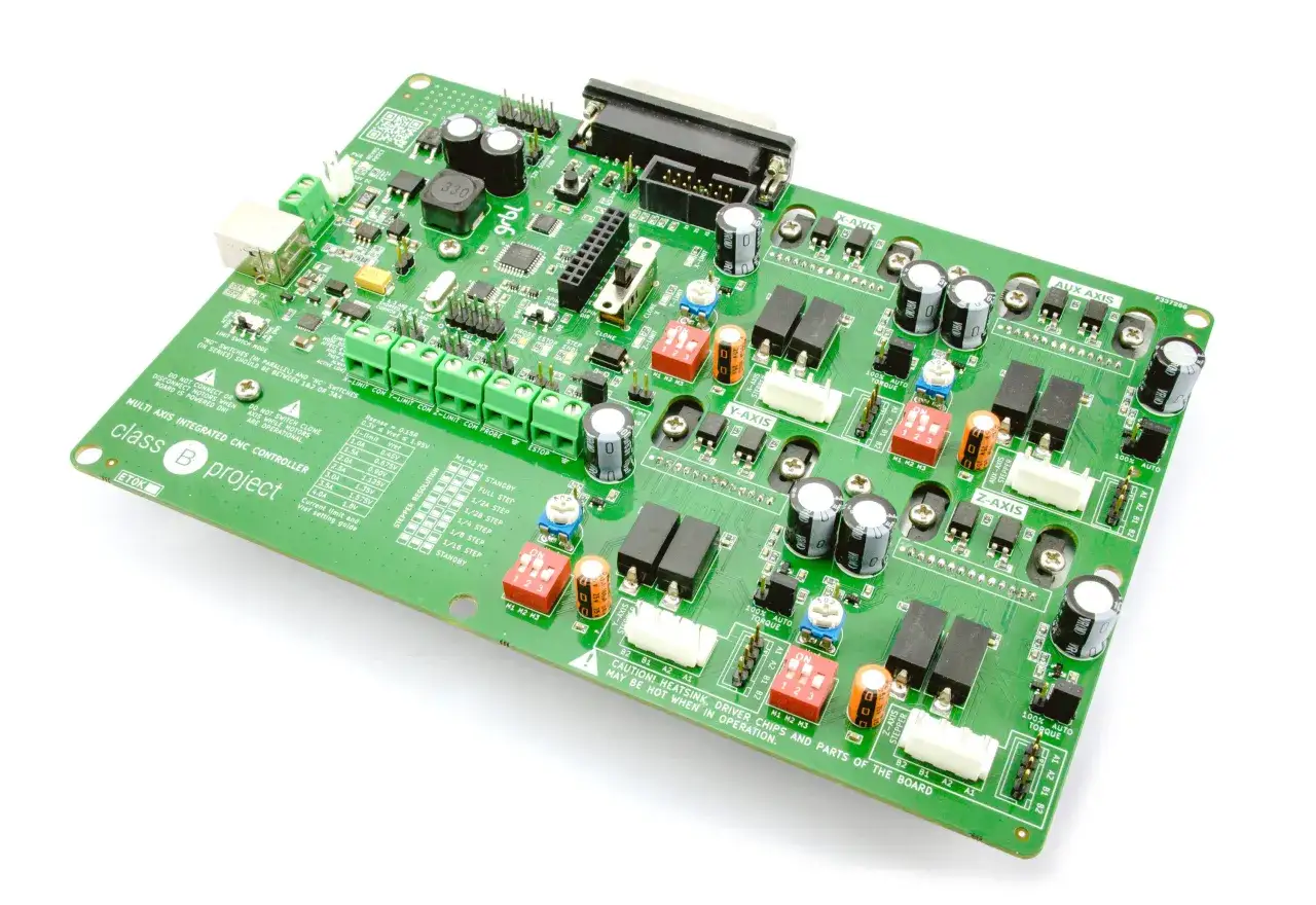 Green circuit board, a Delta Computer Systems controller for CNC machines, featuring multiple axis connections and stepper motor drivers.