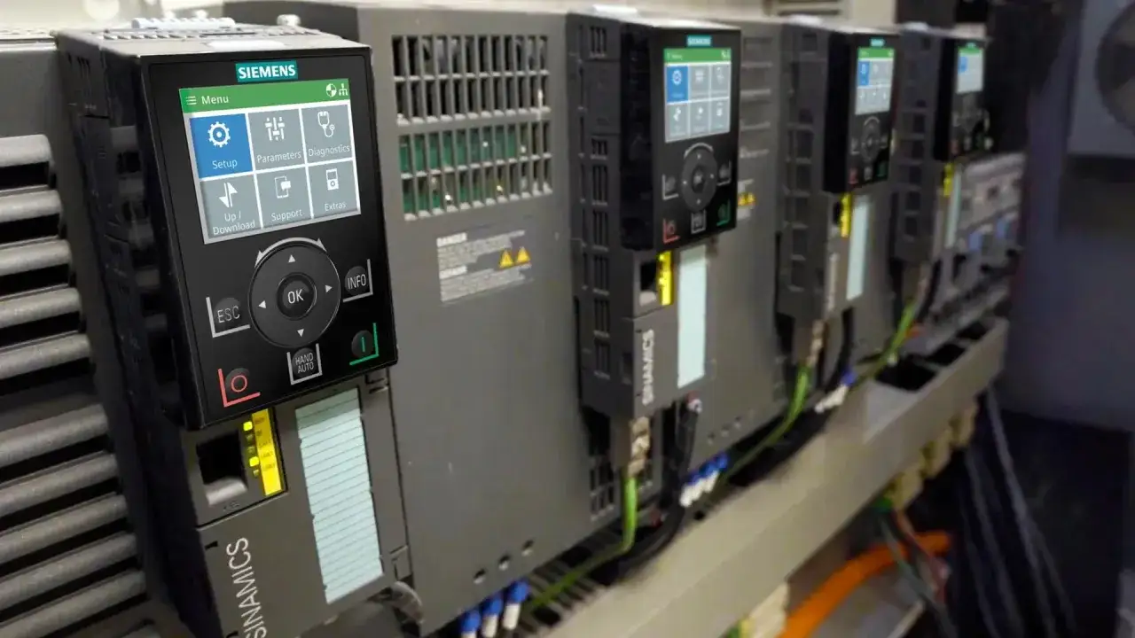 Siemens SINAMICS VFDs lined up, with a close-up on the control panel, ready for vfd troubleshooting.